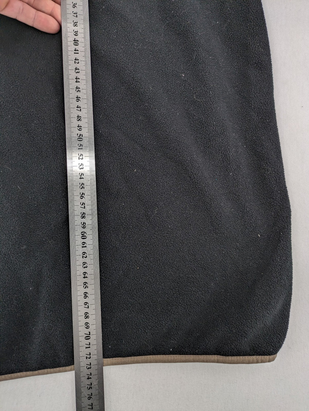 Crane beige and black fleece jacket full zip with cream accents and zippered pockets.