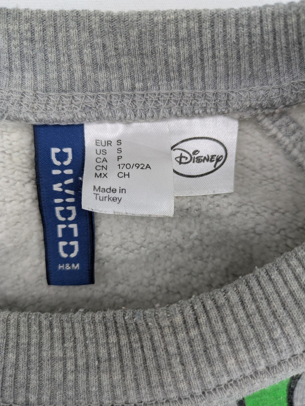 Disney turtle neck jumper multi with colorful Mickey Mouse graphic and "MR. MOUSE" sleeve text.