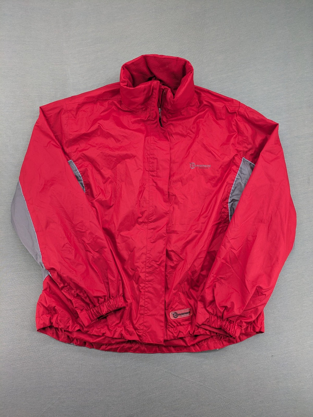 Movement Session grey and red windbreaker jacket with colorblock pattern and full zip.