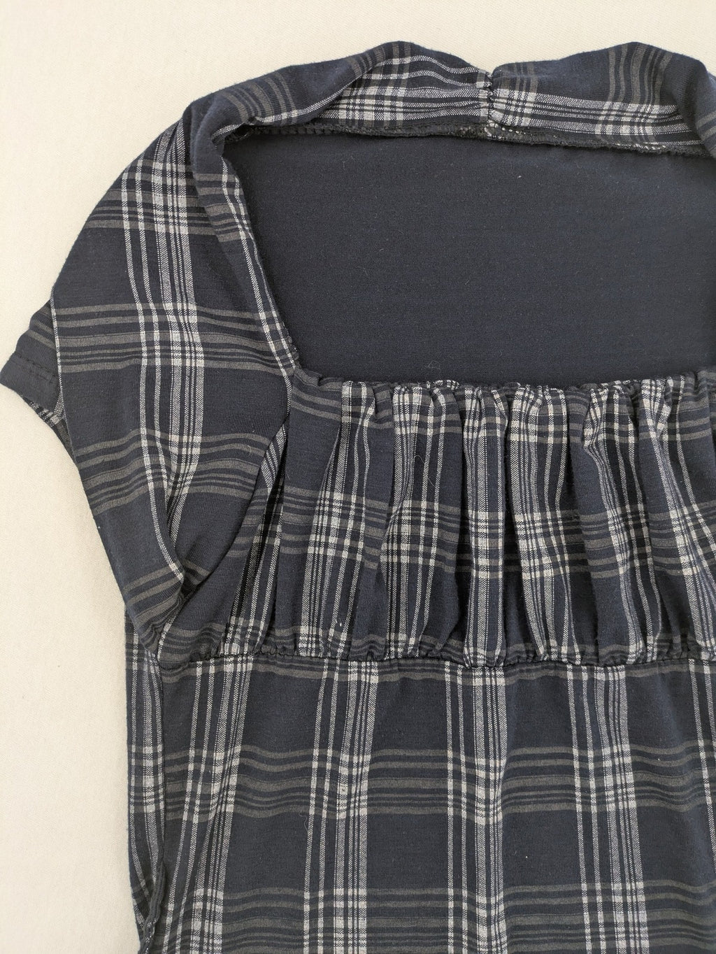Eleganz navy and white checked top with square neckline and gathered bust detail.