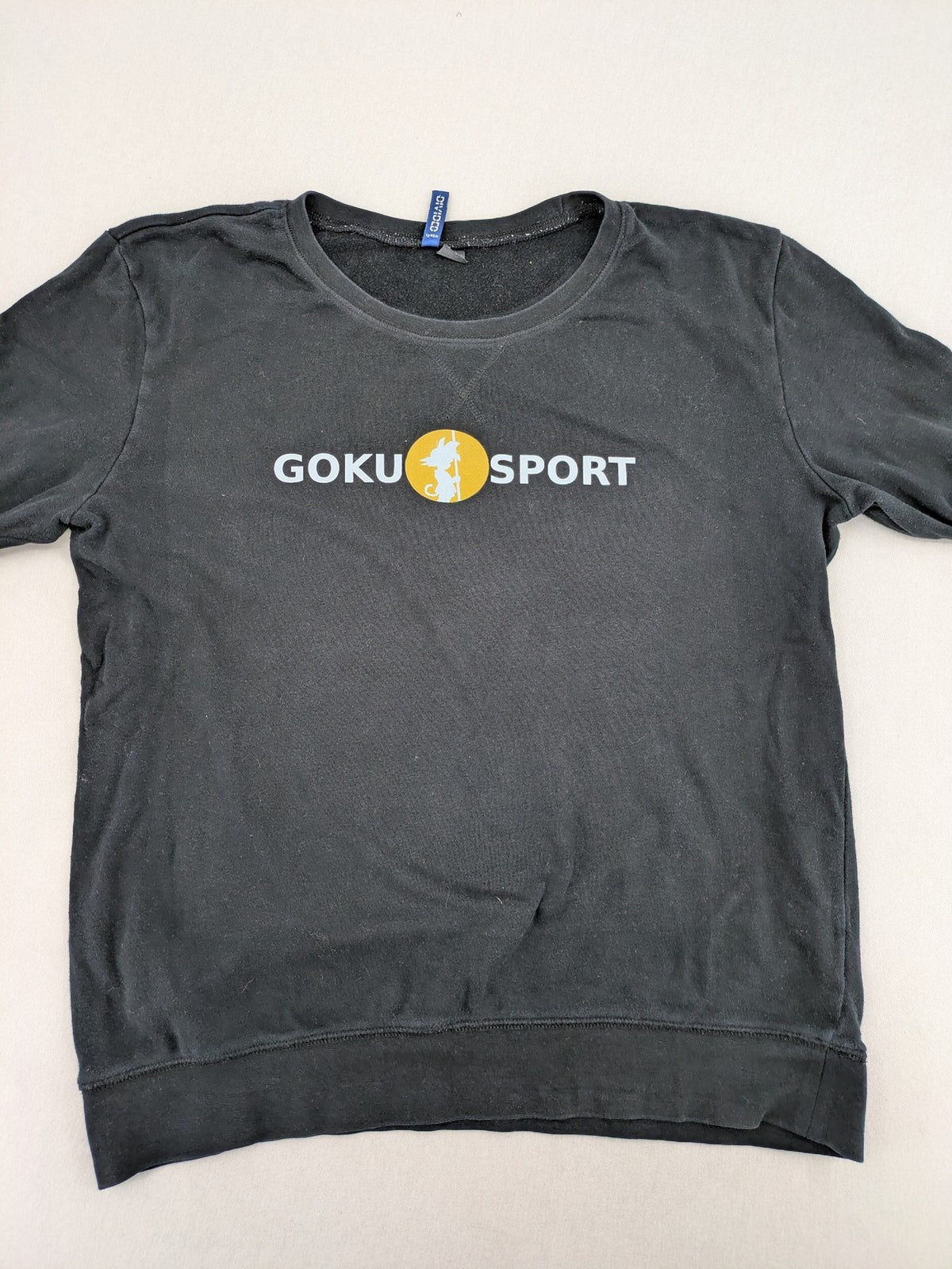 Dragon Ball Z grey turtle neck jumper featuring "GOKU SPORT" graphic print, 100% cotton.