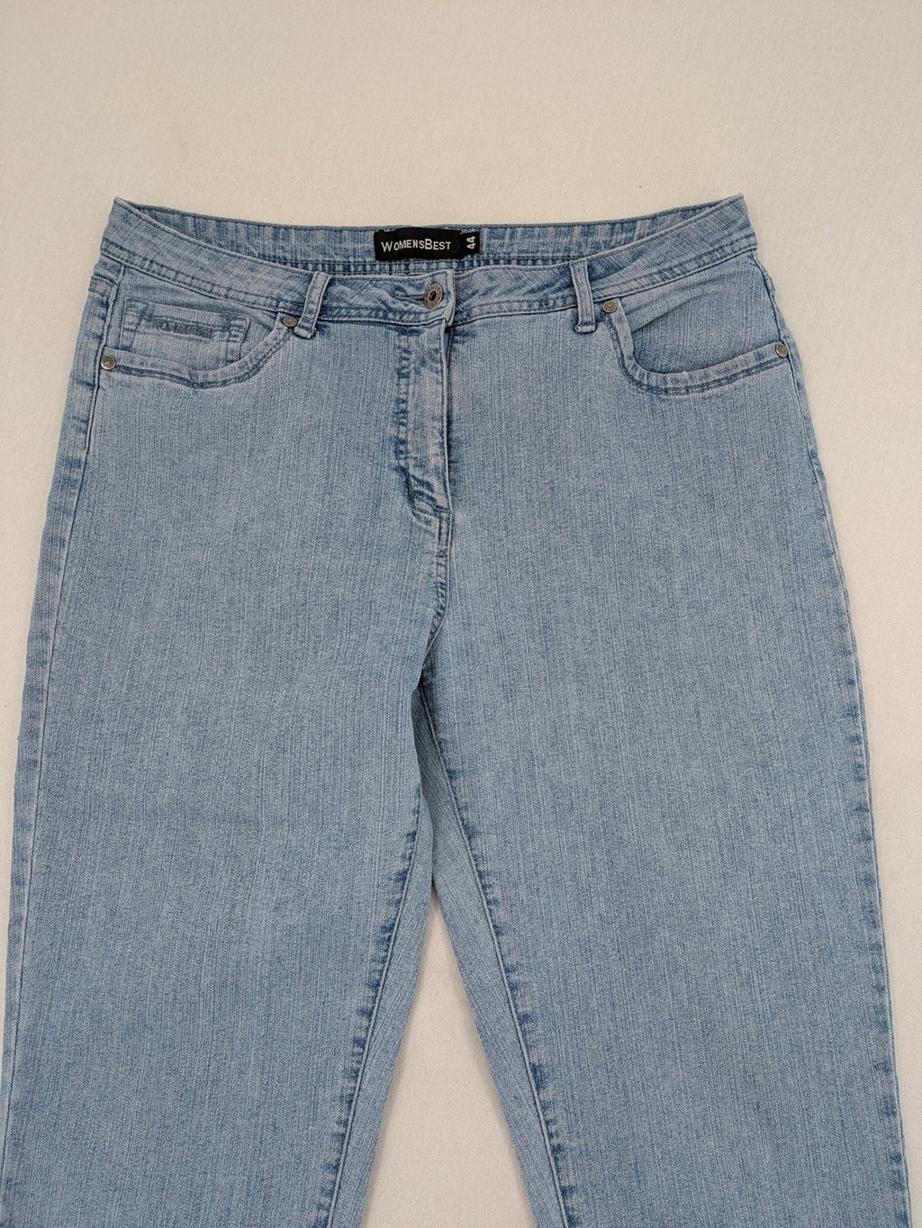 Capri blue straight jeans with 5-pocket design and embroidered details on back pockets.