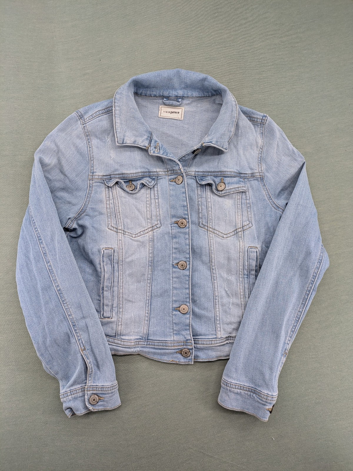 Pimkie blue denim jacket with classic cut, button placket, and two chest pockets.