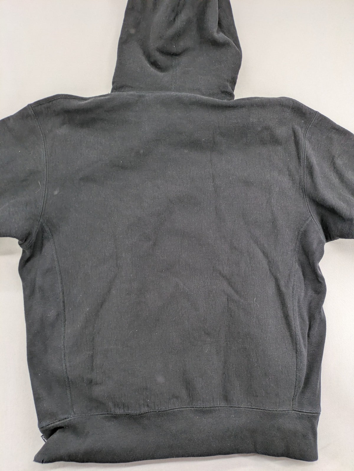 Supreme grey hoodie with embroidered small box logo, kangaroo pocket, and ribbed cuffs.