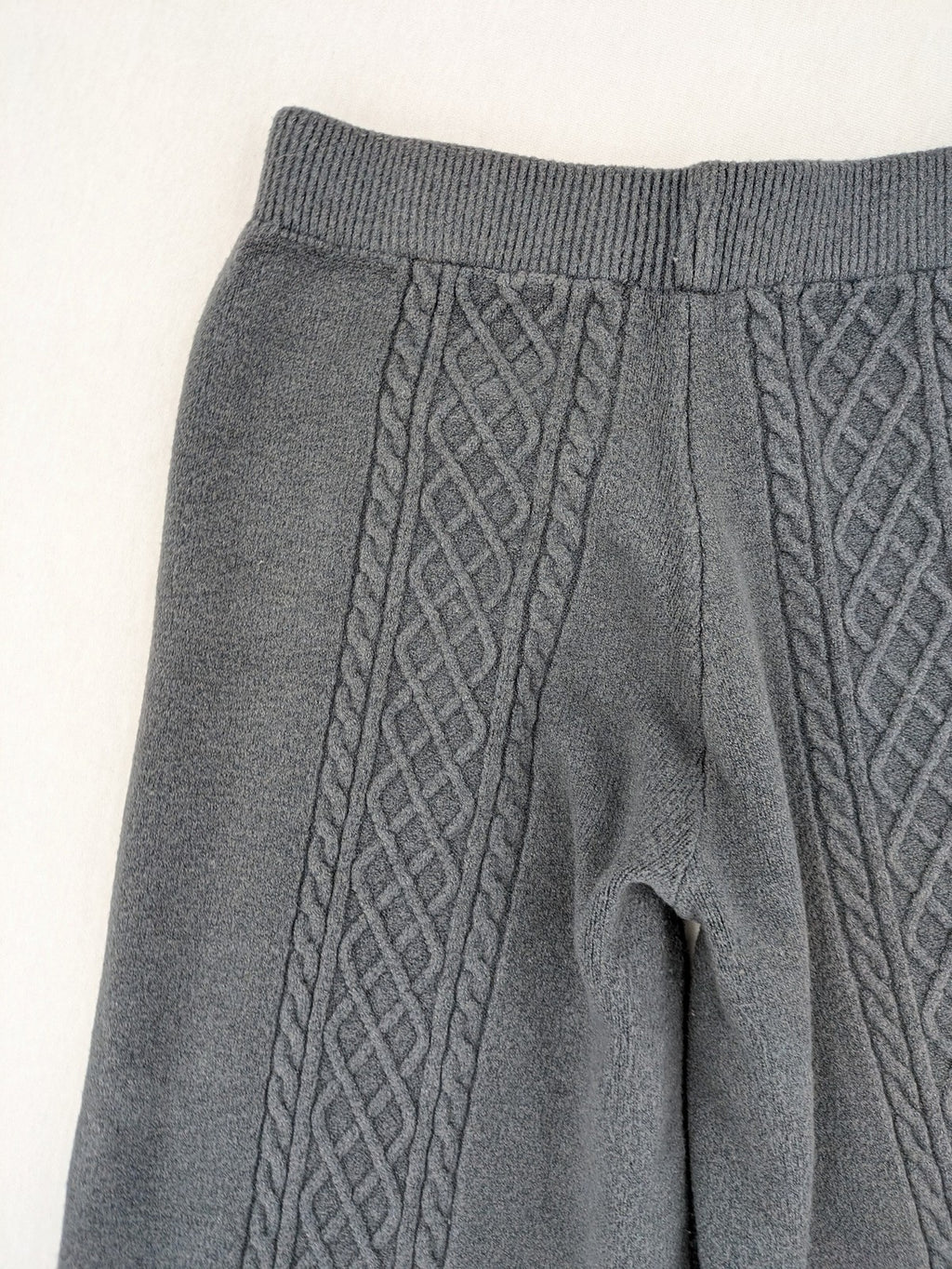 Grey pants with cable knit pattern, wide leg, ribbed waistband, 100% polyester.