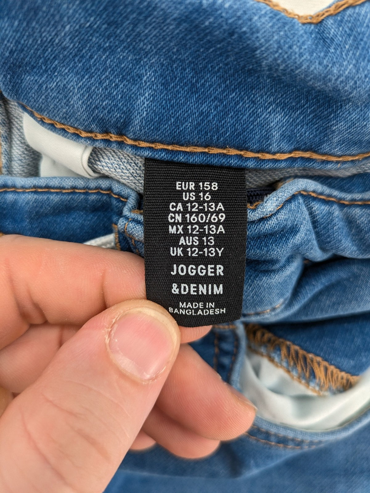 H&M blue straight jeans with elastic waistband and white drawstring, casual jogger style.