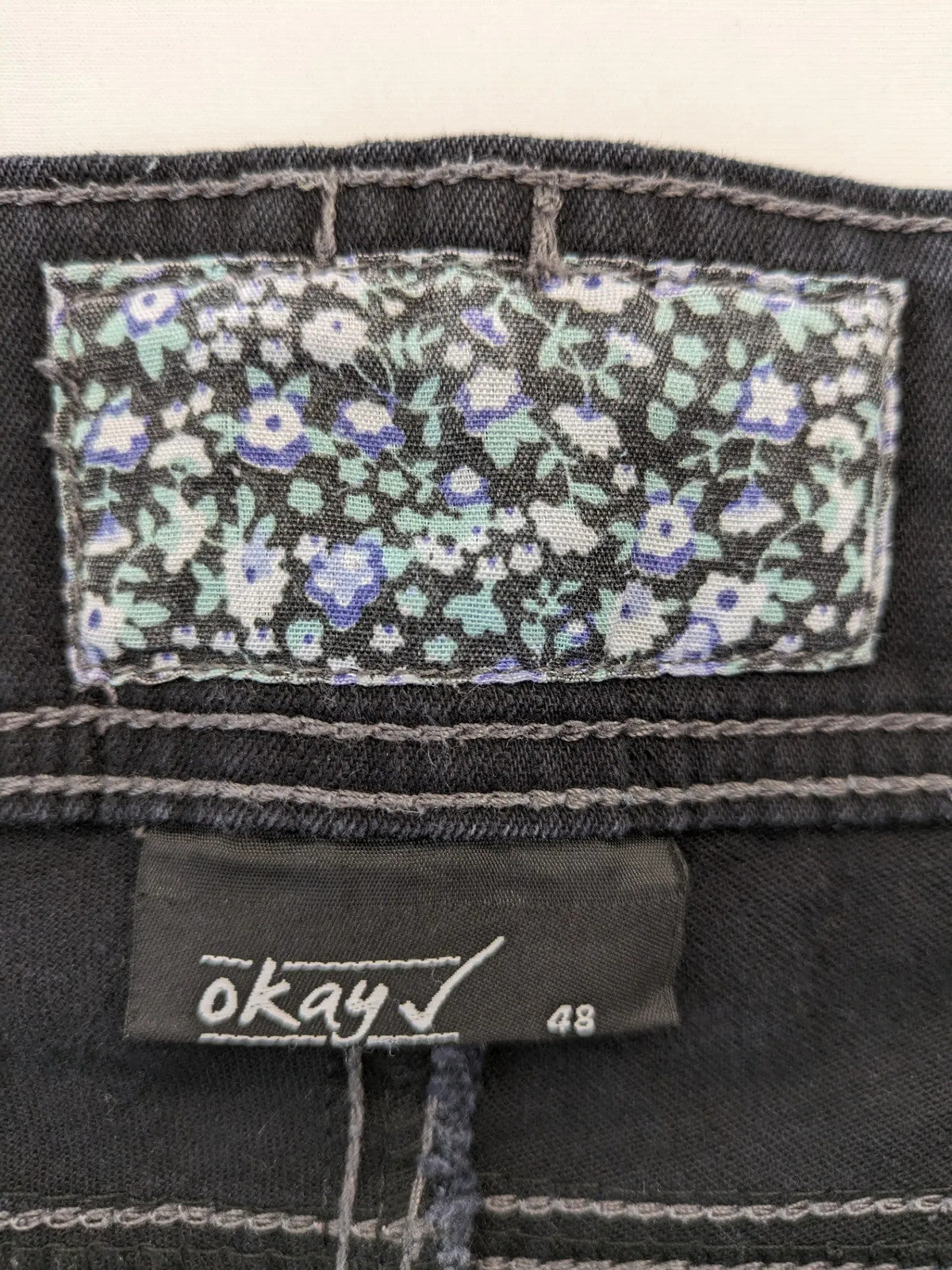 Okay grey straight jeans with contrast stitching and three-button closure, cotton stretch material.