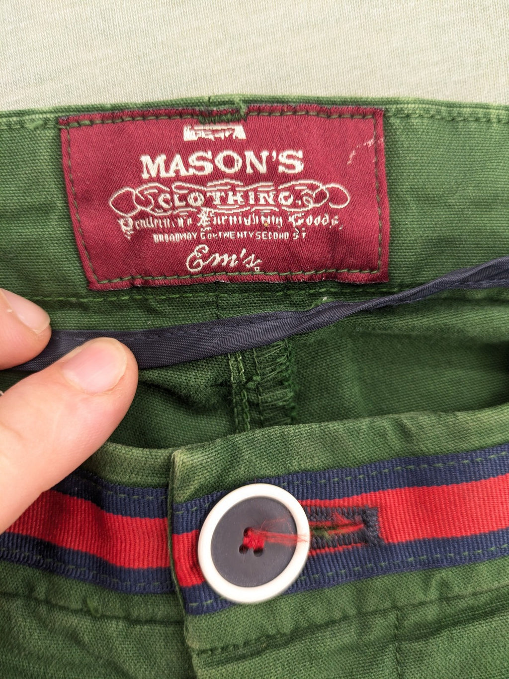 Mason's green chino pants with striped red and blue waistband, cotton stretch material.