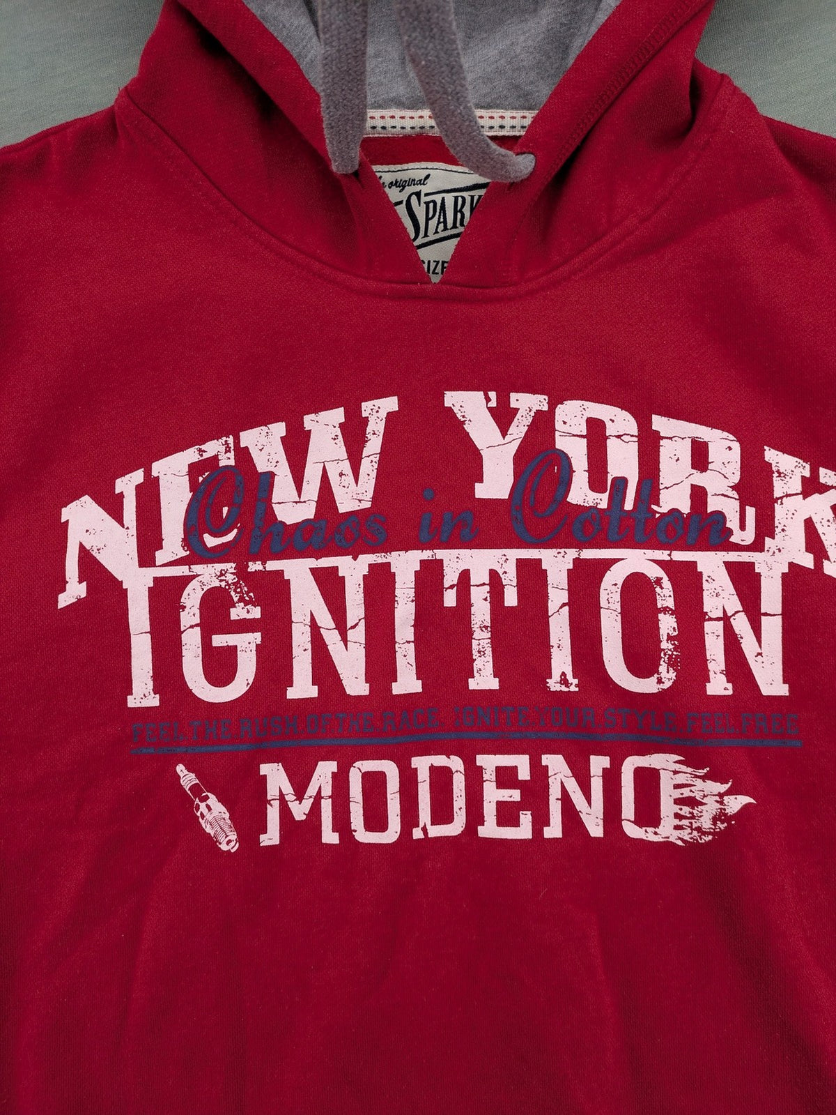 Sparks red zip-through hoodie with New York graphic print and grey hood.