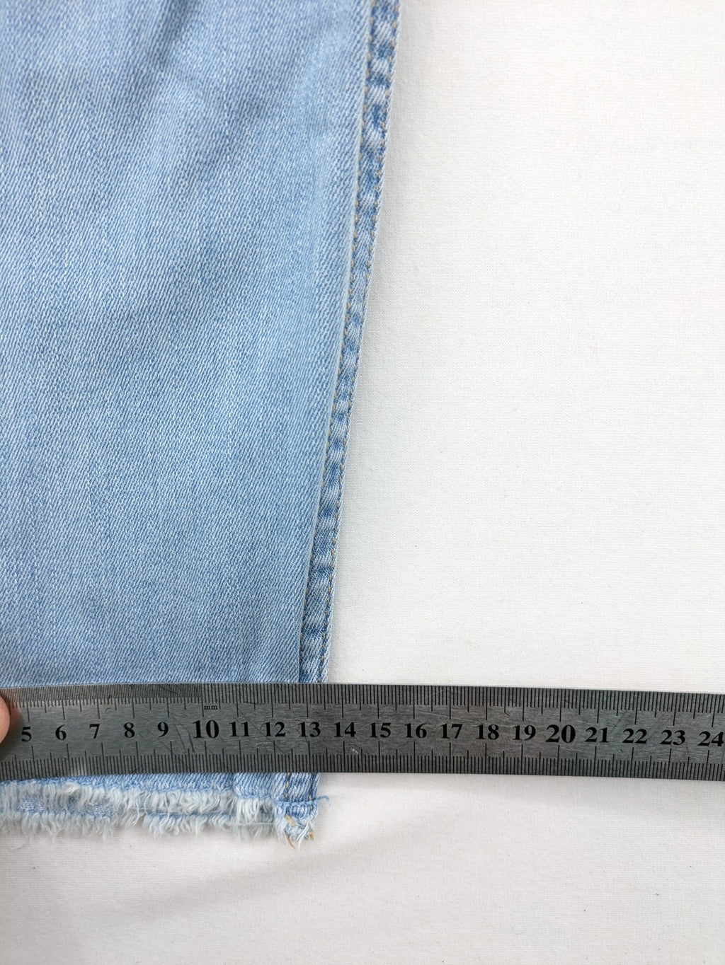 Hollister blue high-rise crop super skinny jeans with distressed rips and frayed hem.