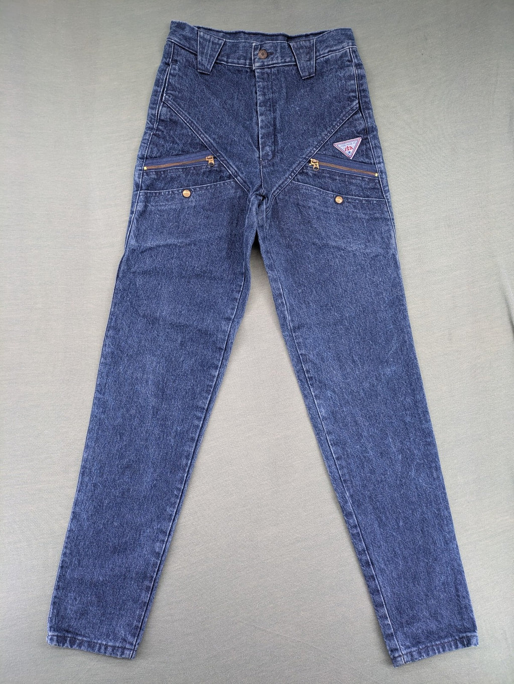 YKK blue high waist mom jeans with decorative front zipper pockets and vintage denim texture.