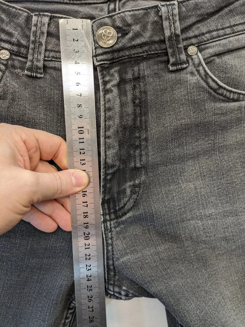 Denim grey straight jeans 5-pocket design with subtle brand details and zipper closure.