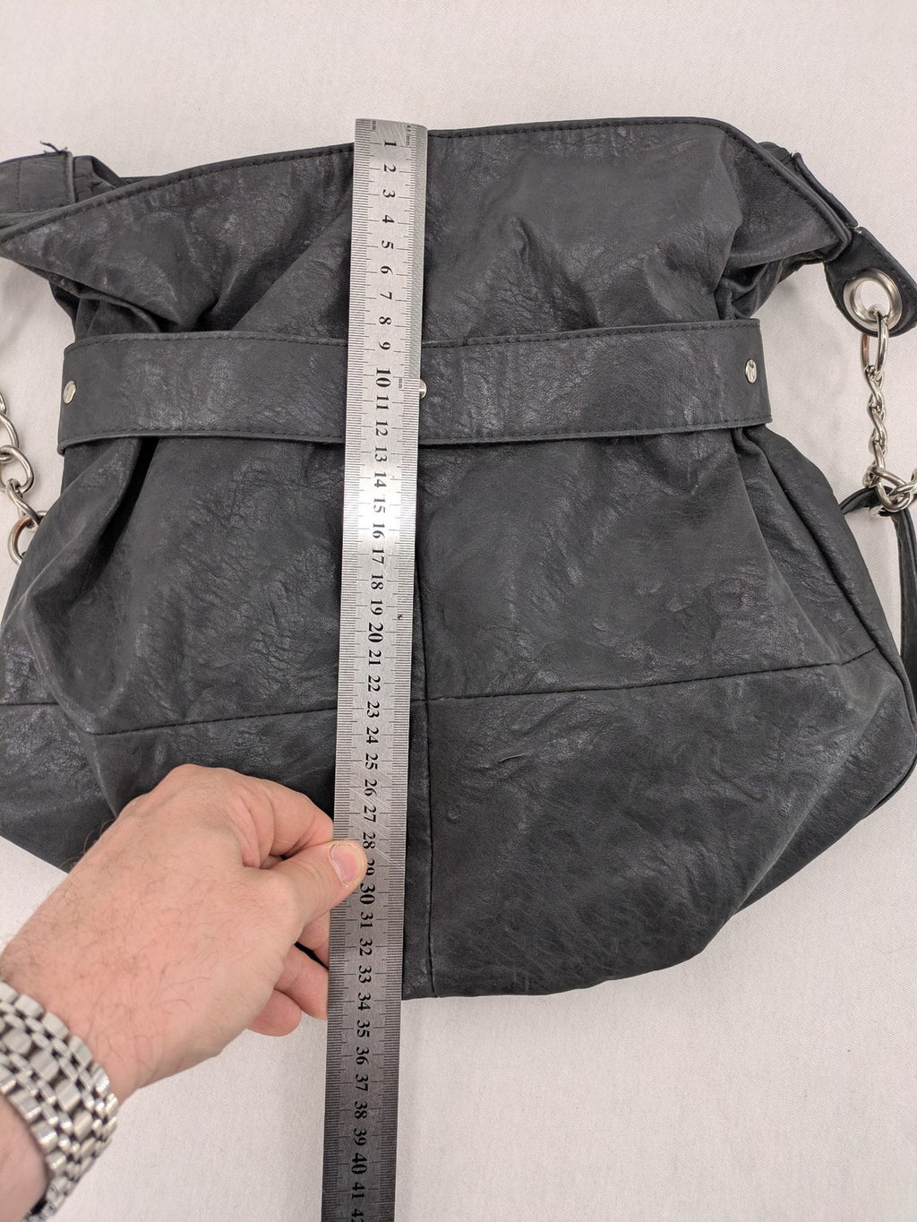 New Yorker black hobo handbag with silver chain details and large eyelets.