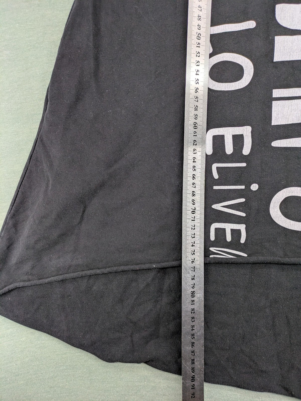 MEGI Collection black hoodie dress with graphic print and asymmetrical high-low hem.