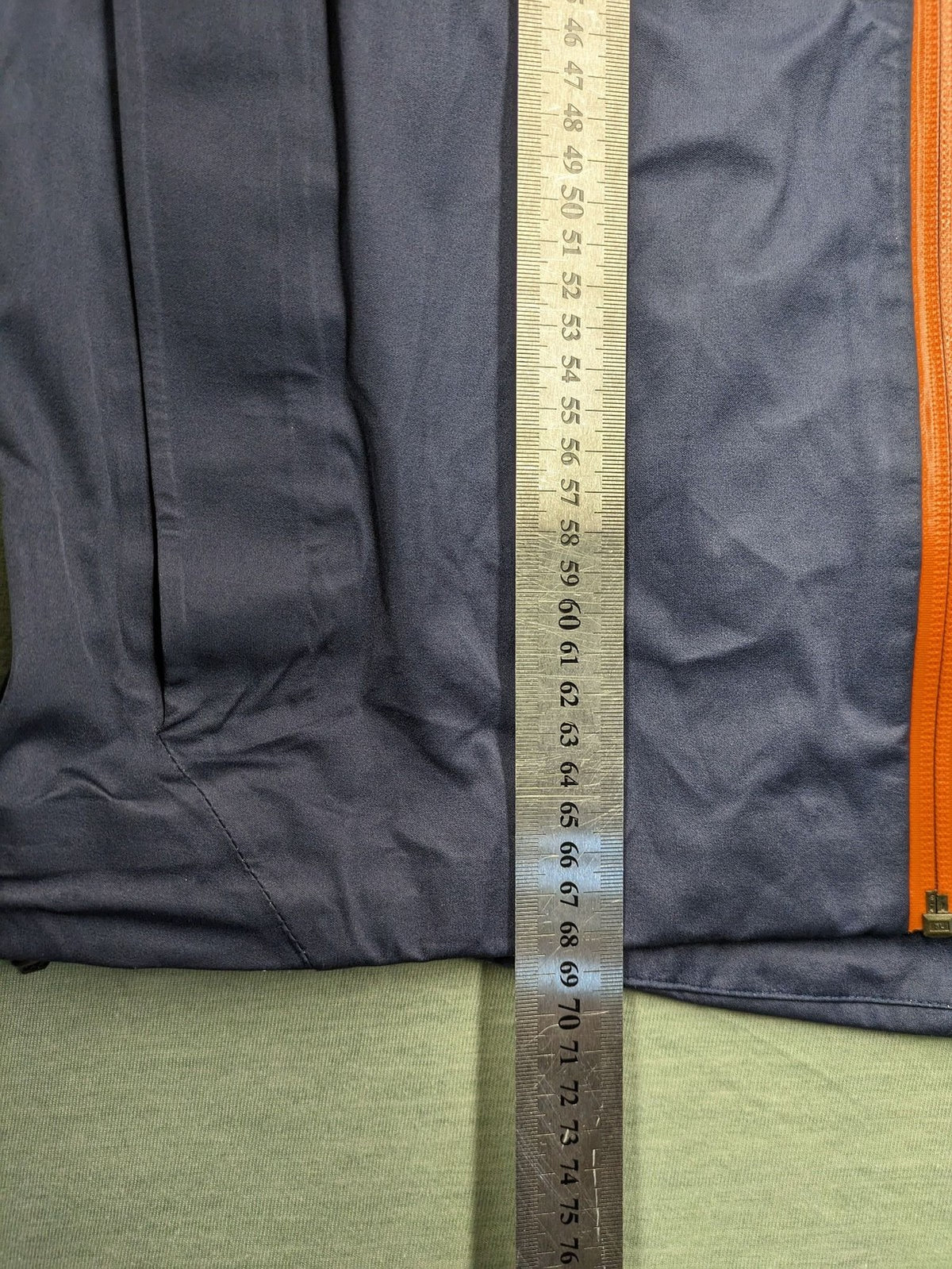 Cross Sportswear orange golf jacket with full zip, high collar, and contrast zipper details.