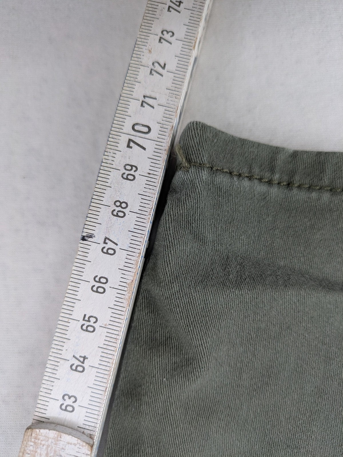 Page One Young khaki motorcycle pants with stitched panels and decorative zipper details.