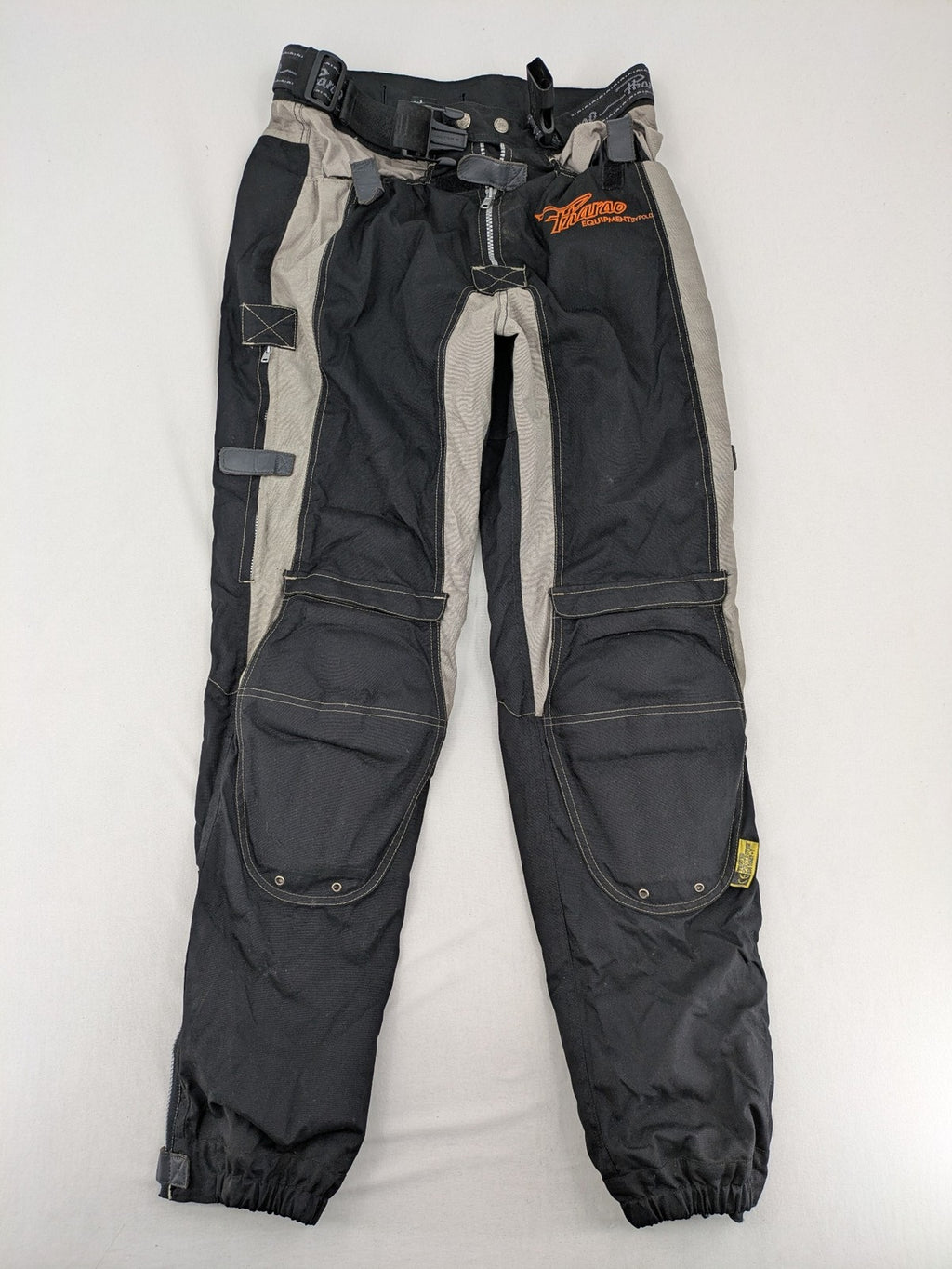 Pharao cream chaps with integrated knee protectors and adjustable waist belt.