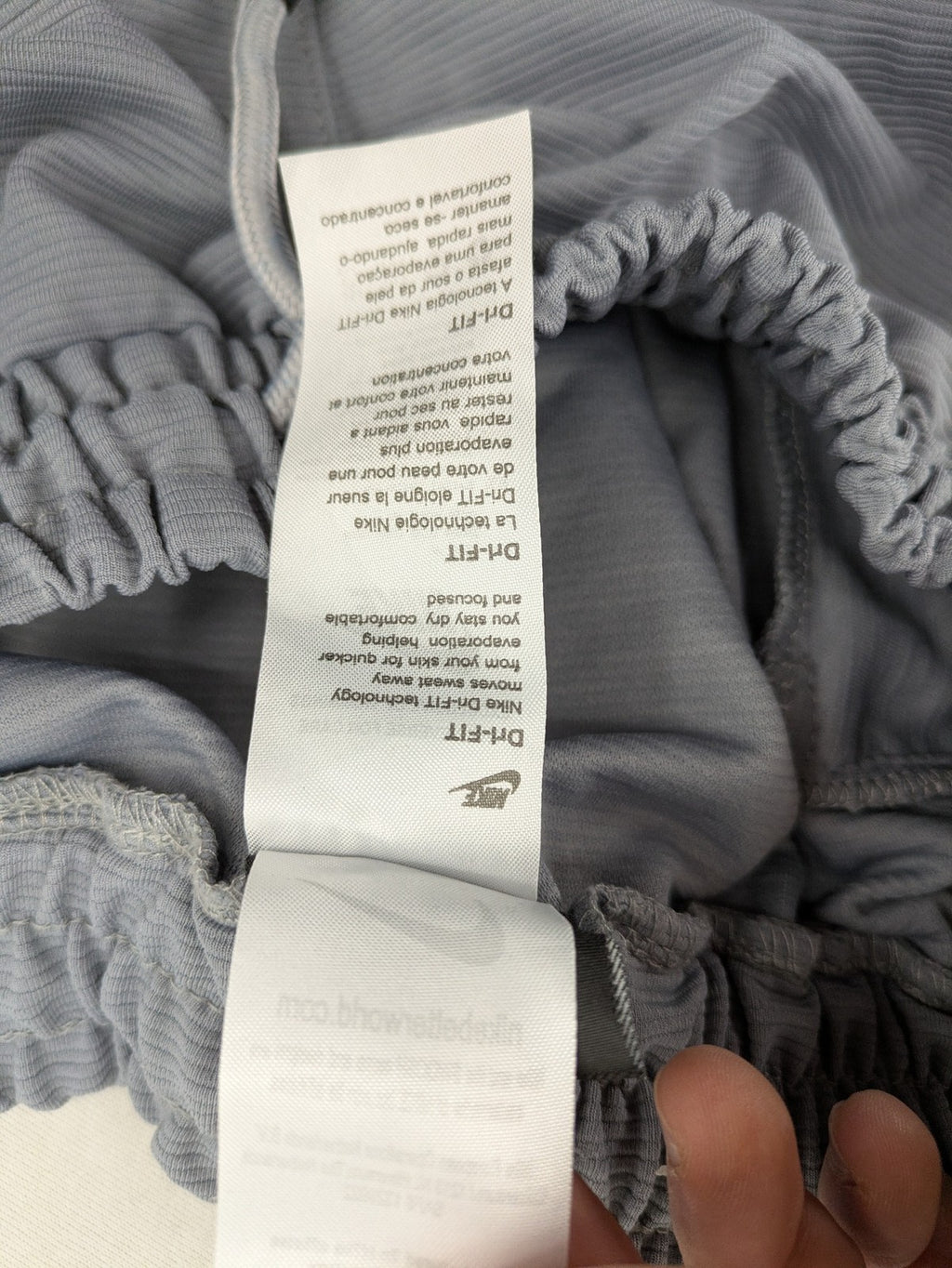 Nike grey shorts with Dri-FIT technology, elastic waistband, and zippered pockets.