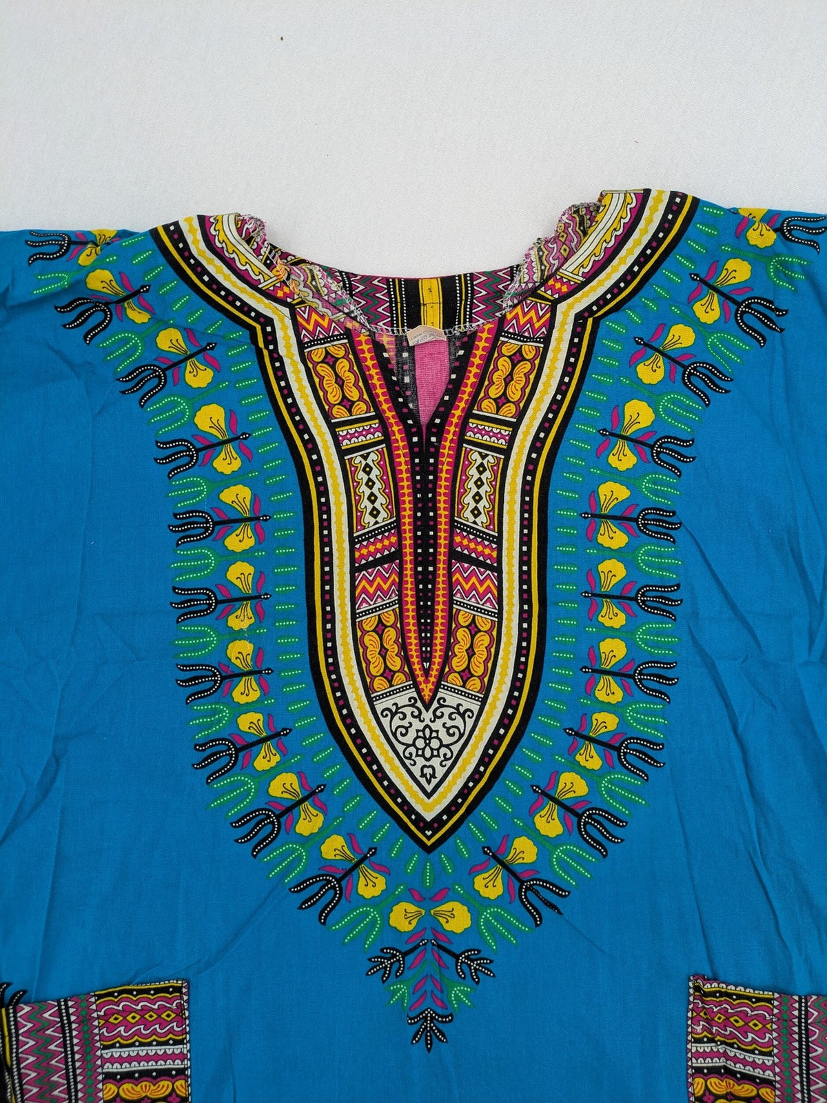 M/L multi Dashiki shirt with vibrant ethnic print on light blue cotton fabric.