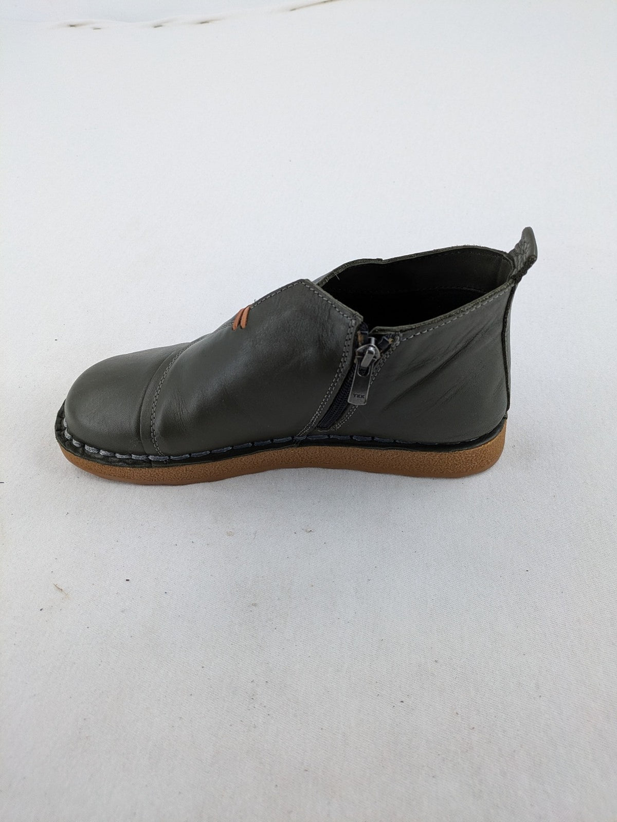 ALS green leather booties with side zipper and decorative stitching.