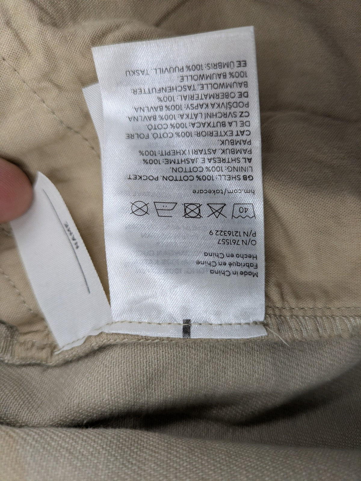 H&M beige twill coat with full zip, classic collar, and practical pockets.