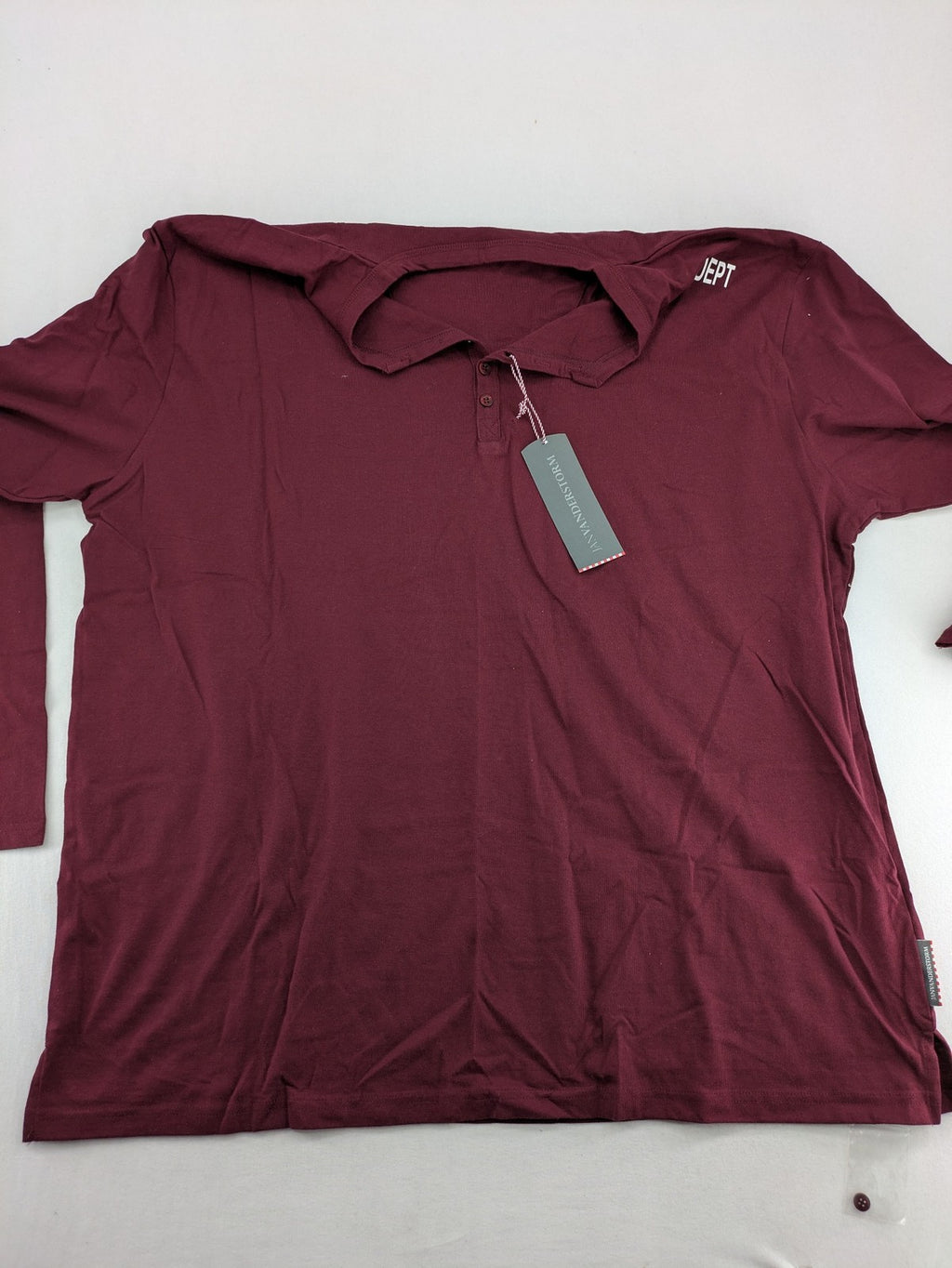 Jan Vanderstorm burgundy Henley shirt with button placket and "087 JV DEPT" graphic print.