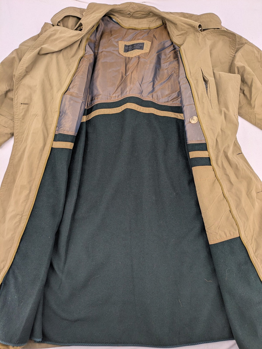 Studio Novum khaki trench coat double-breasted design with belt and wool lining.