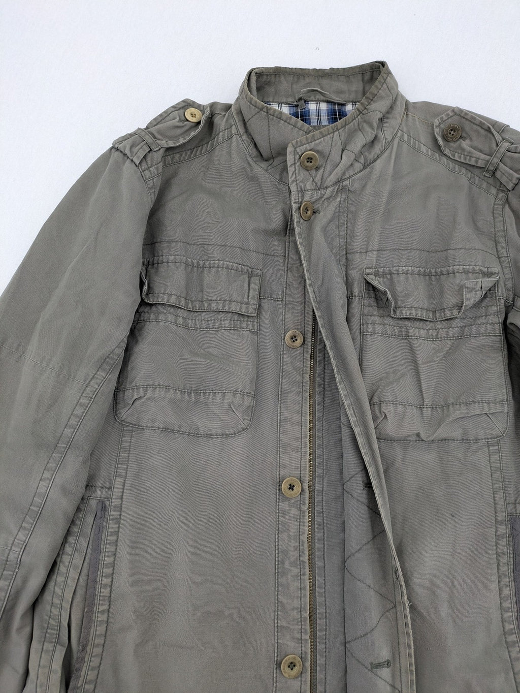 Walbusch khaki military jacket with checkered blue-white lining and multiple pockets.