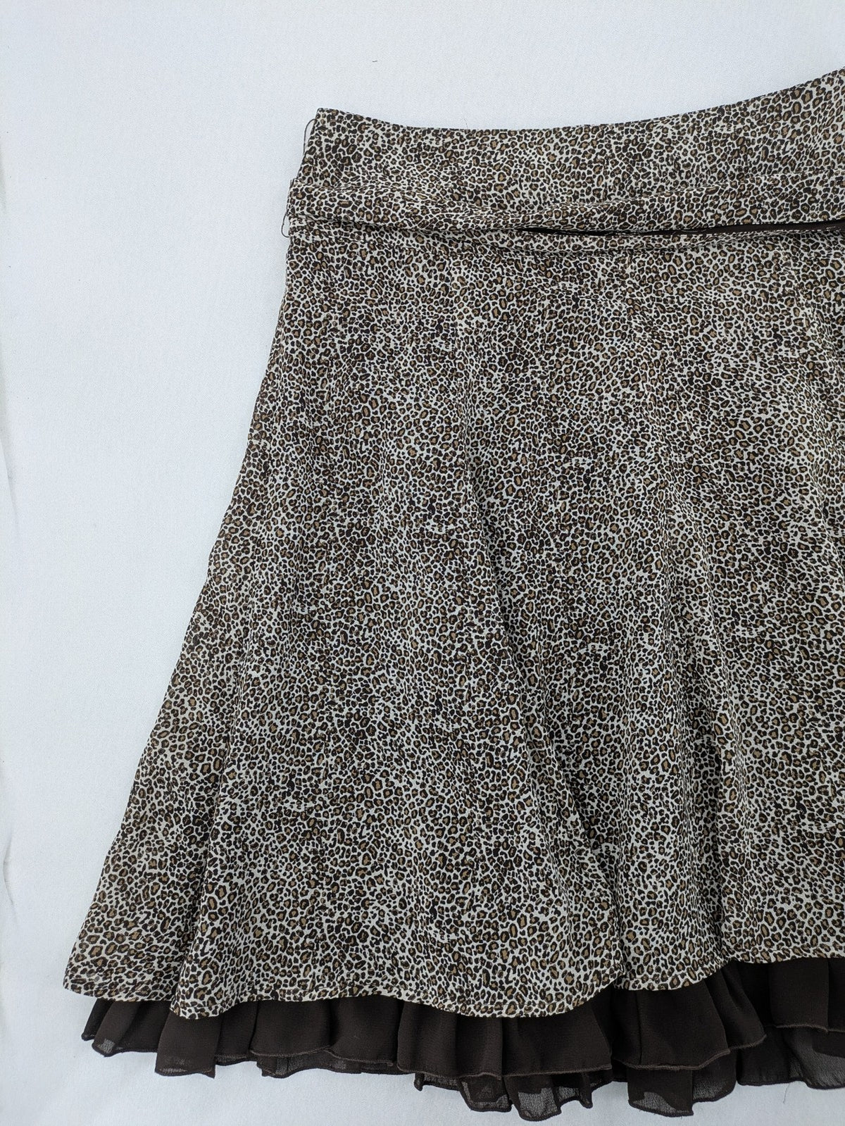 H&M women's A-line skirt beige brown leopard print ruffled hem and side tie detail.