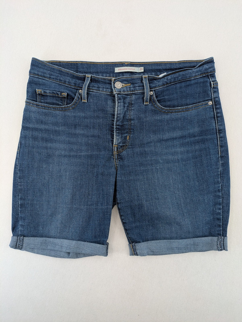 Levi's blue denim Bermuda shorts with rolled cuffs and classic 5-pocket design.