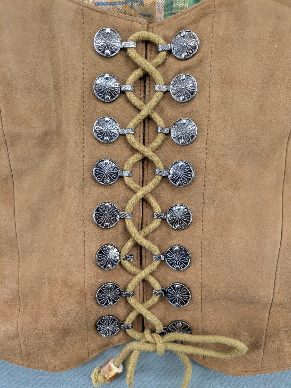 St. Moritz multi Trachtenweste brown genuine leather with decorative lacing and colorful satin lining.