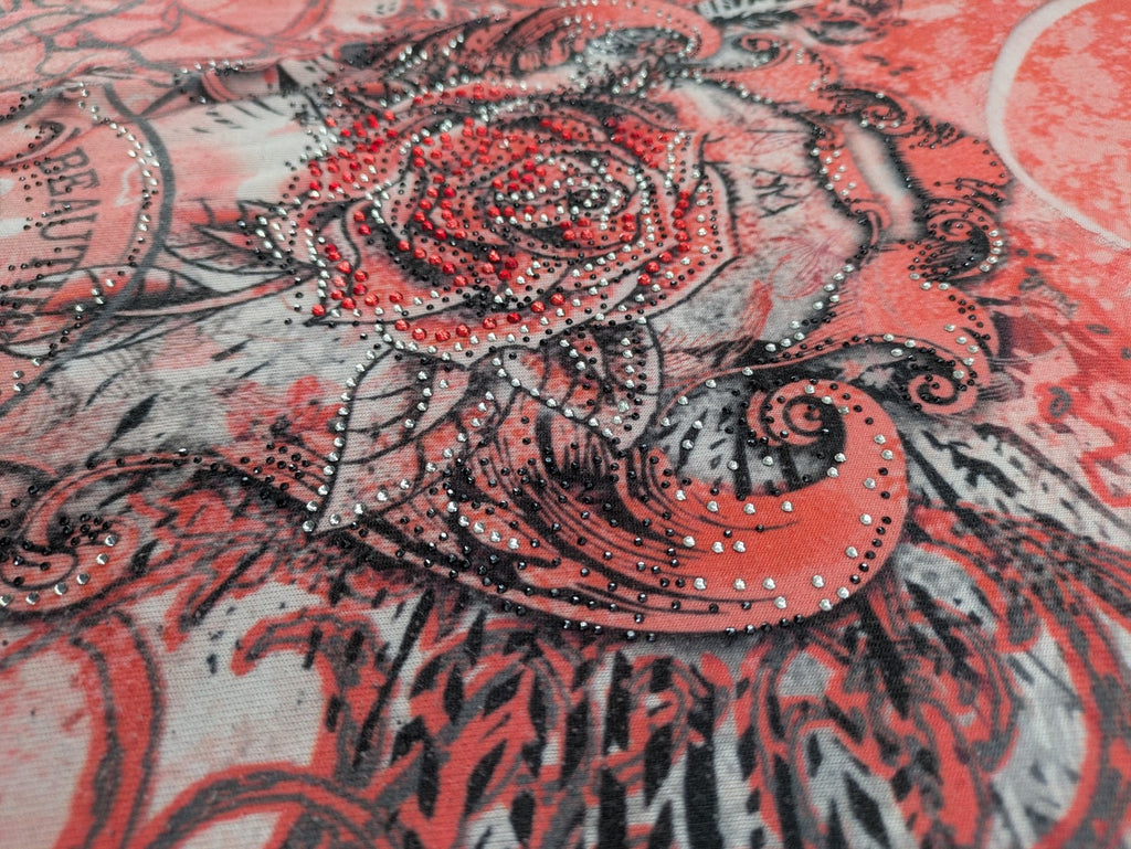 TREDY pink graphic top with rose and wings design, embellished with rhinestones.