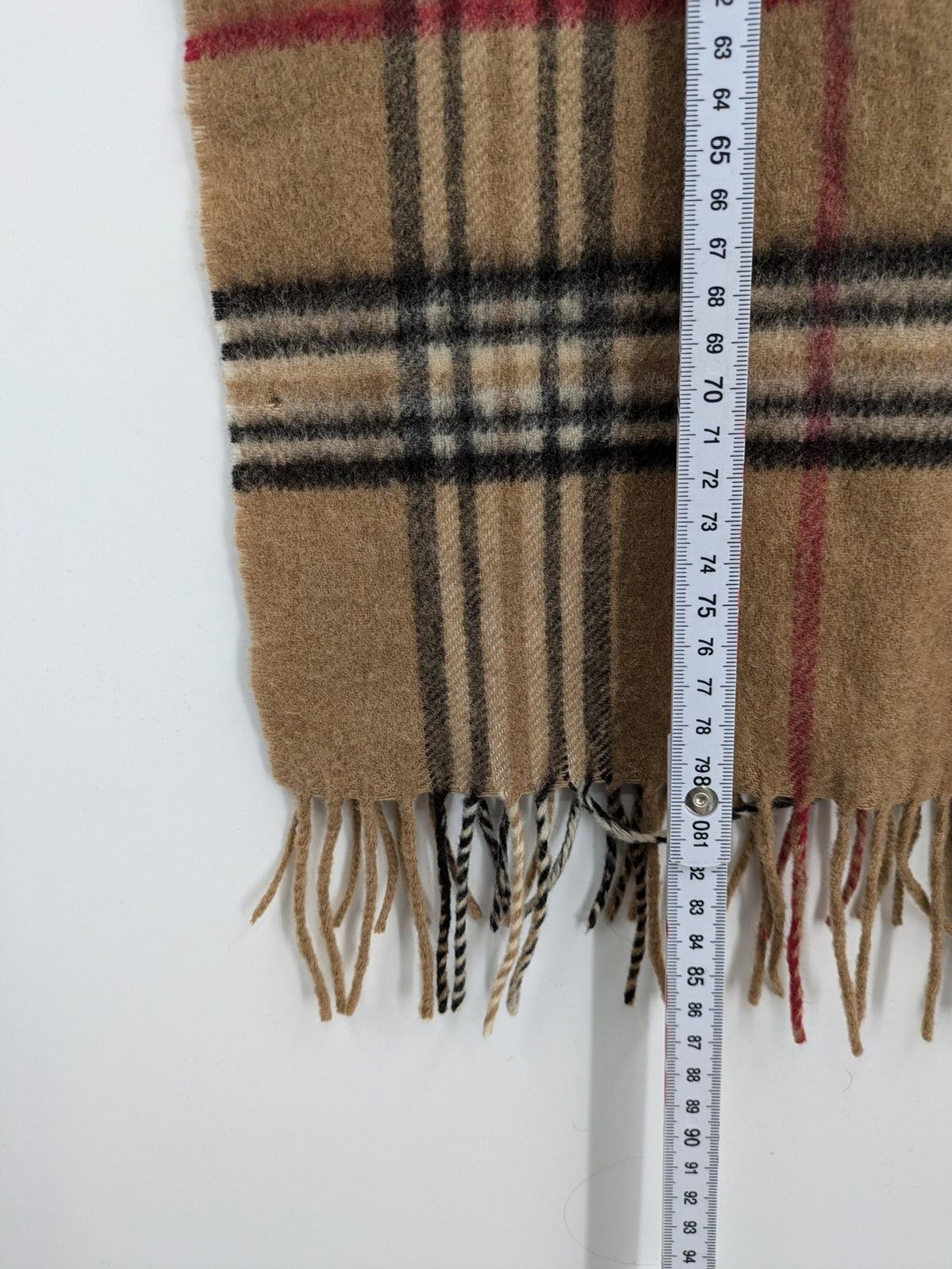 Karo unisex scarf camel brown tartan pattern 100% cashmere with black, white, and red accents.