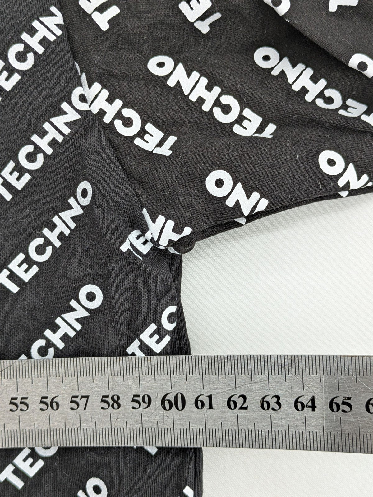 Fresh Cut black techno t-shirt all-over print with bold "TECHNO" graphic design.