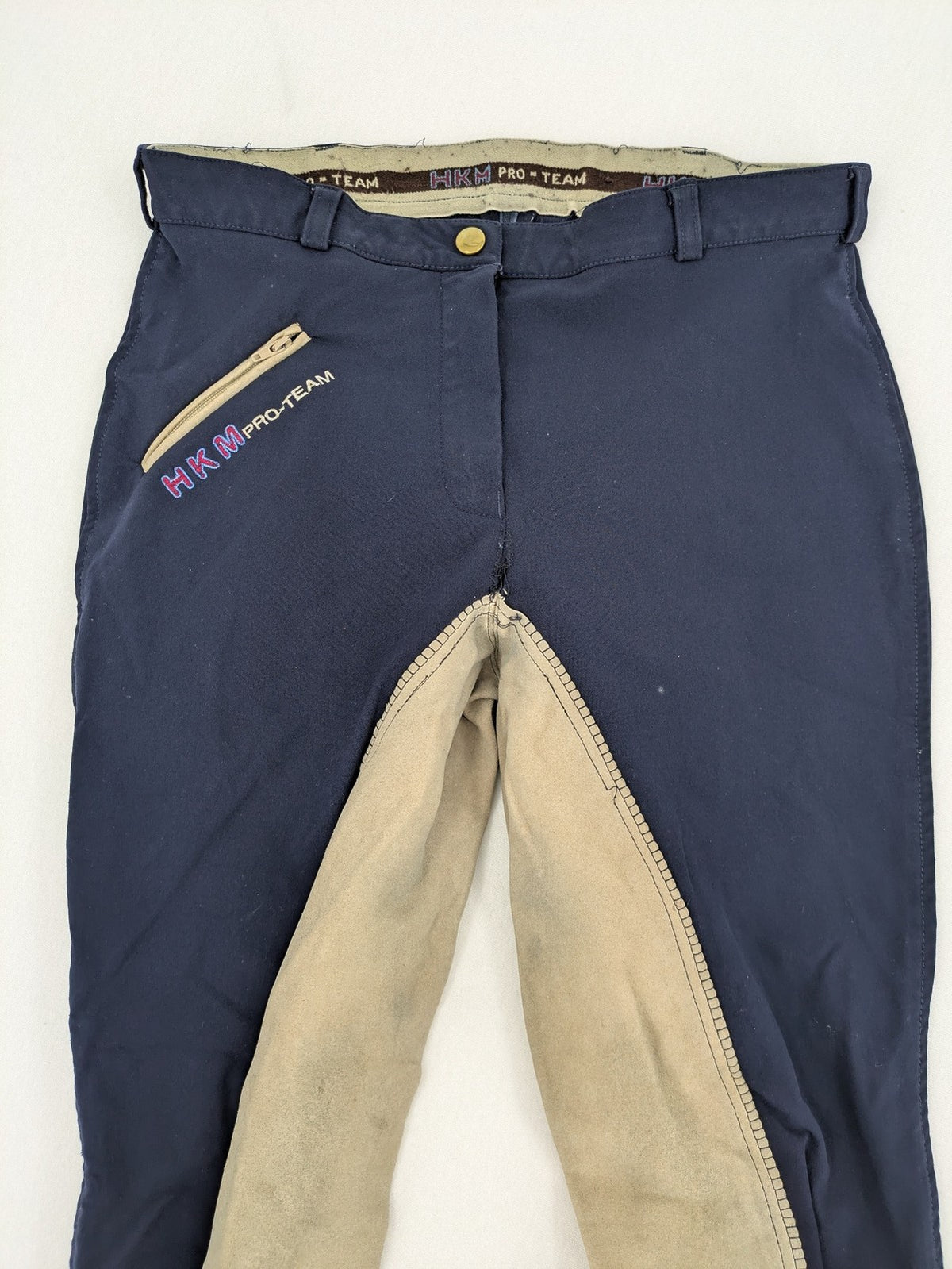 H&KM beige riding pants with dark blue full seat and front zippers.