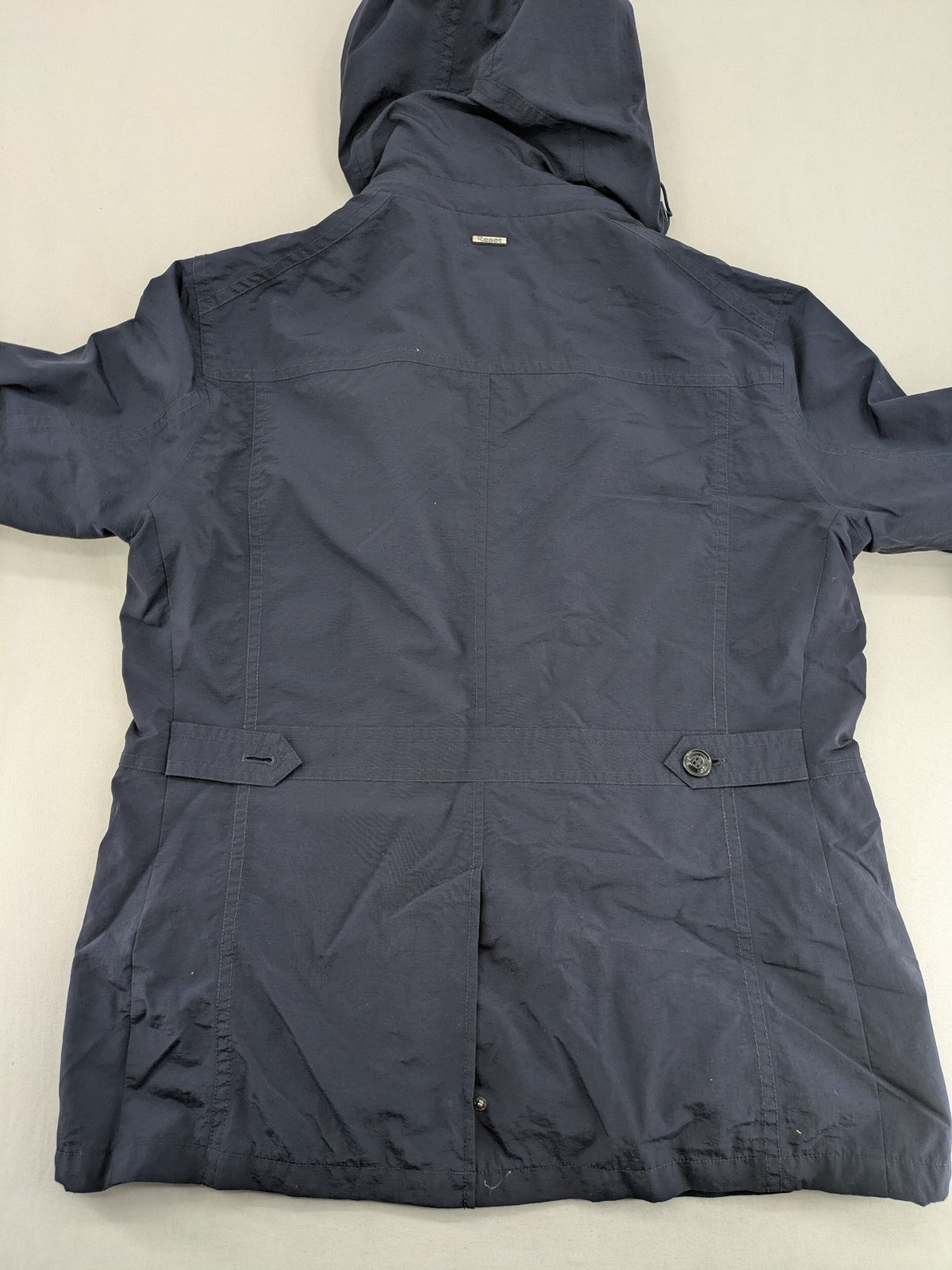 Reset navy parka jacket windproof with adjustable hood and zippered chest pocket.