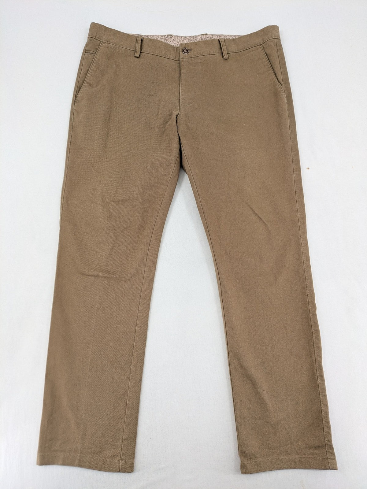 Süvari khaki chino pants flat-front design with patterned waistband detail, cotton blend material.