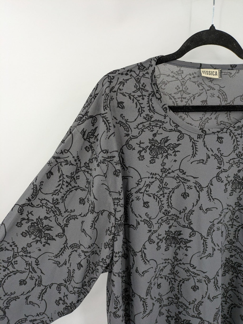 Yessica grey black floral pattern tunic top with round neckline and long sleeves.
