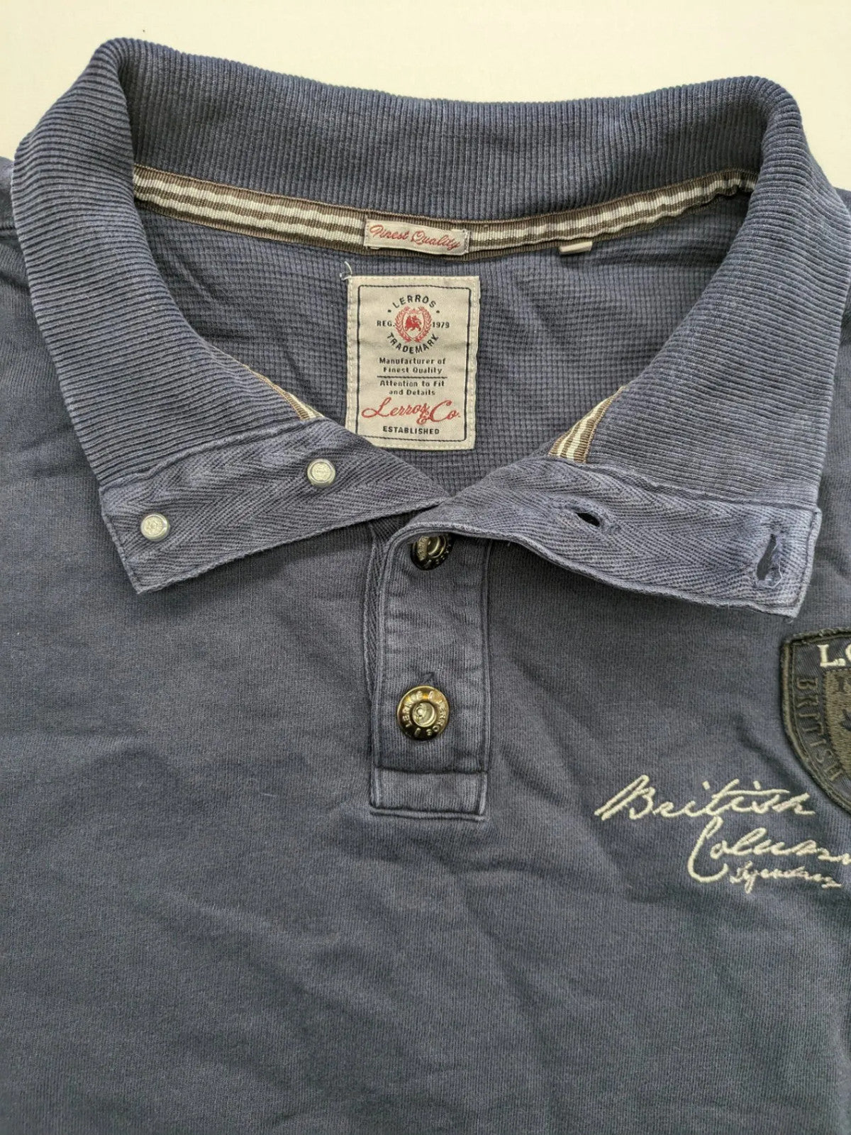 Lerros blue turtle neck jumper with stitched 'British Columbia' detail and button accents.