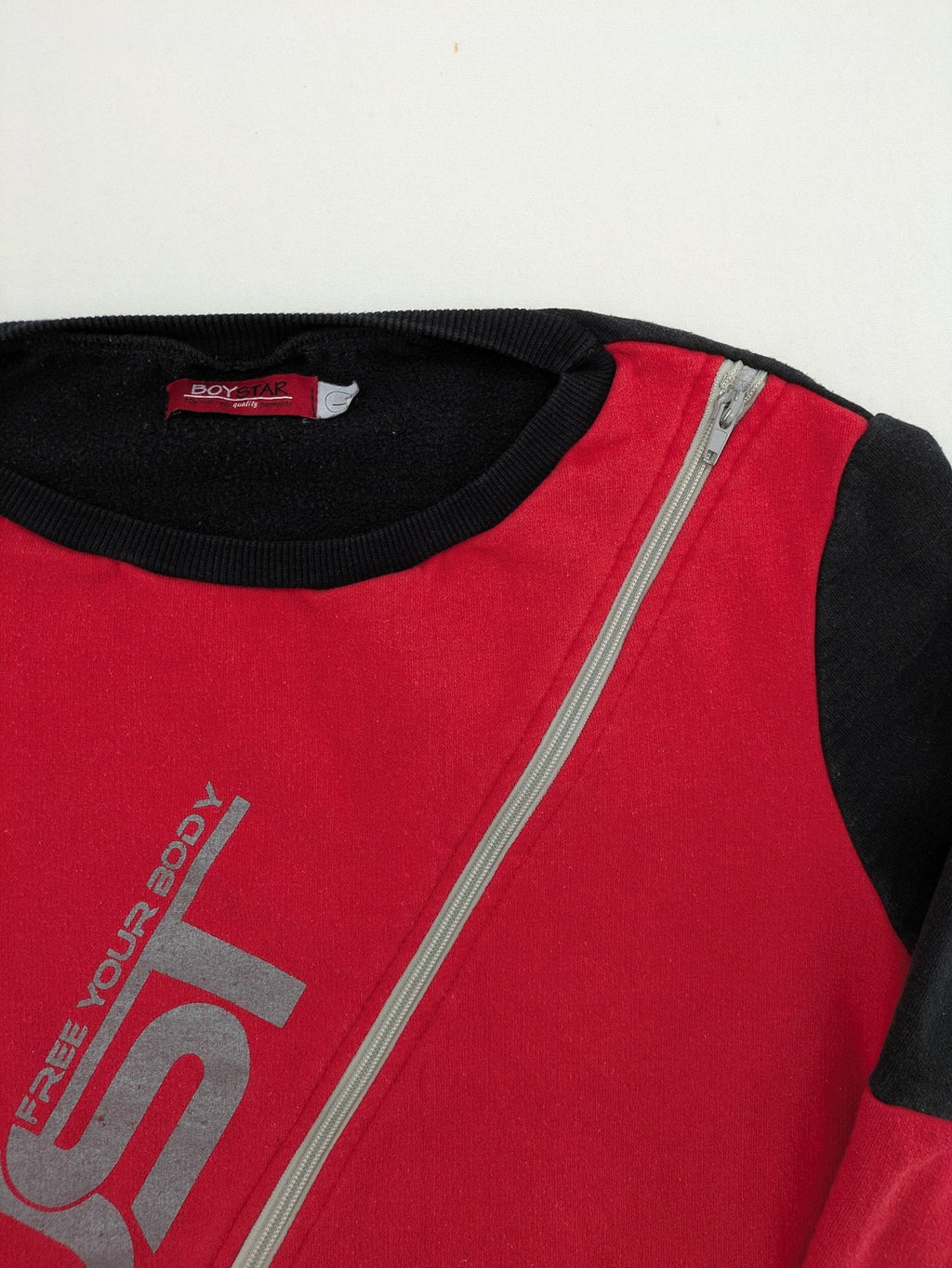Boystar vintage turtle neck jumper red black colorblock with "MUST FREE YOUR BODY" graphic.