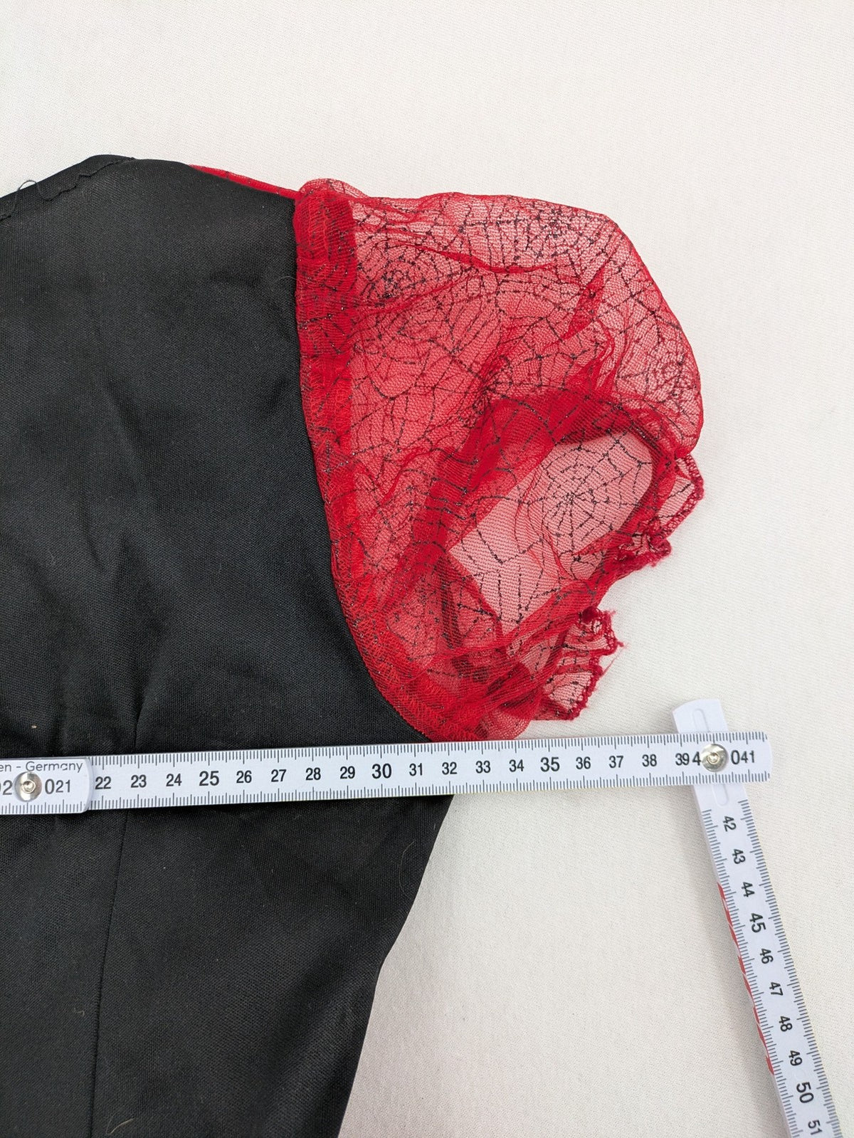 Perfekt red and black costume dress with corset lacing and spiderweb sleeves.