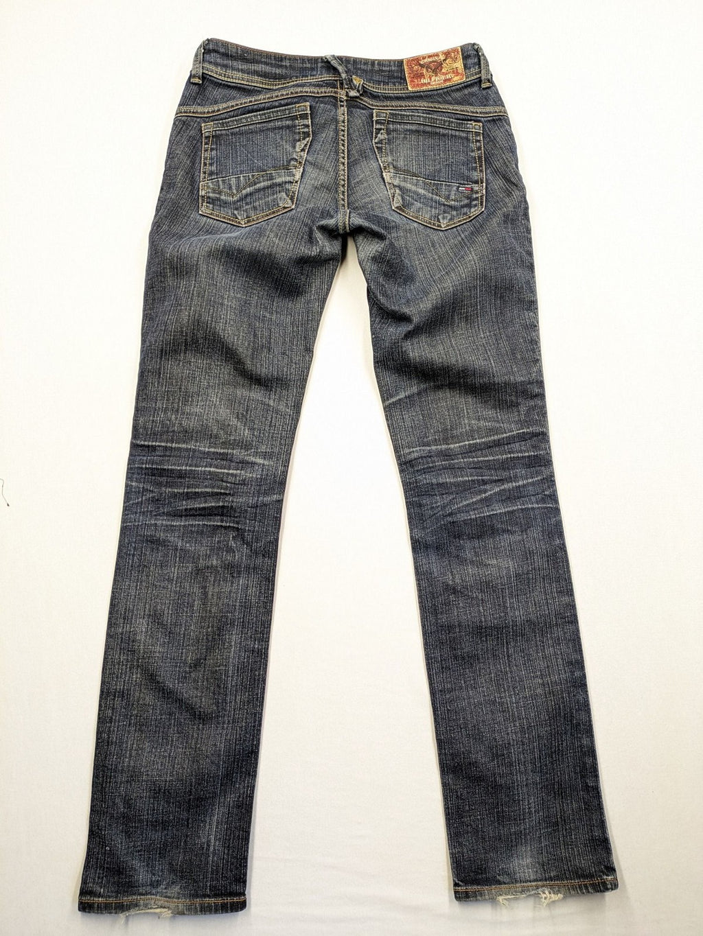 Tommy Hilfiger Denim blue straight jeans with low rise and slight used effects.