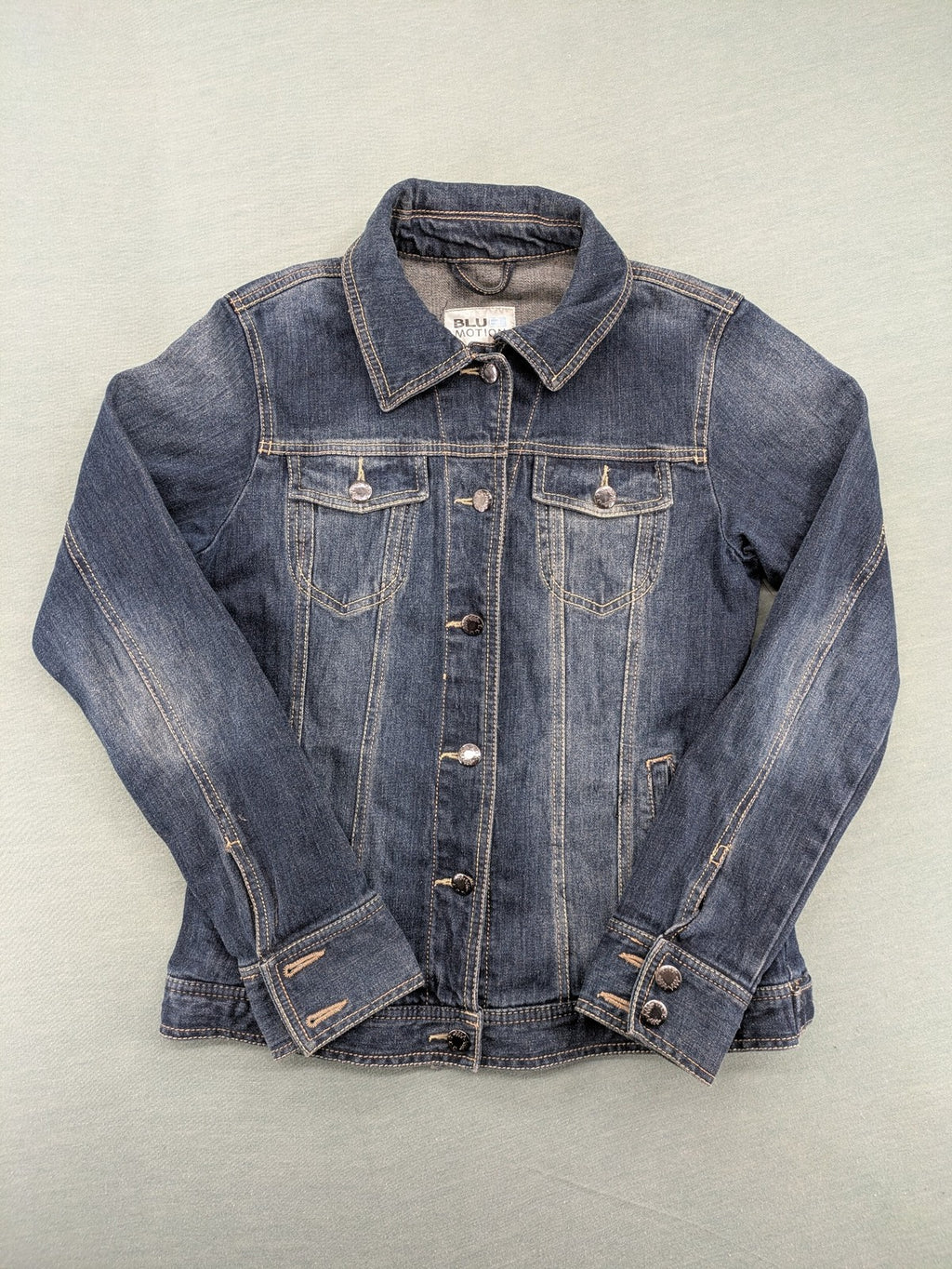 BLU blue denim trucker jacket with button placket and two chest pockets.