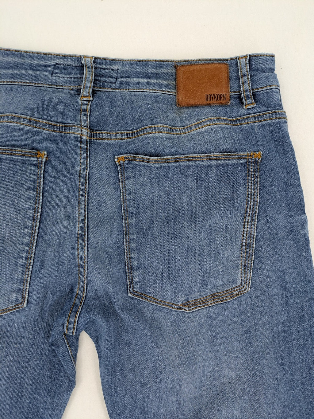 Drykorn blue straight jeans with stretch denim, classic fit, and logo patch on waistband.