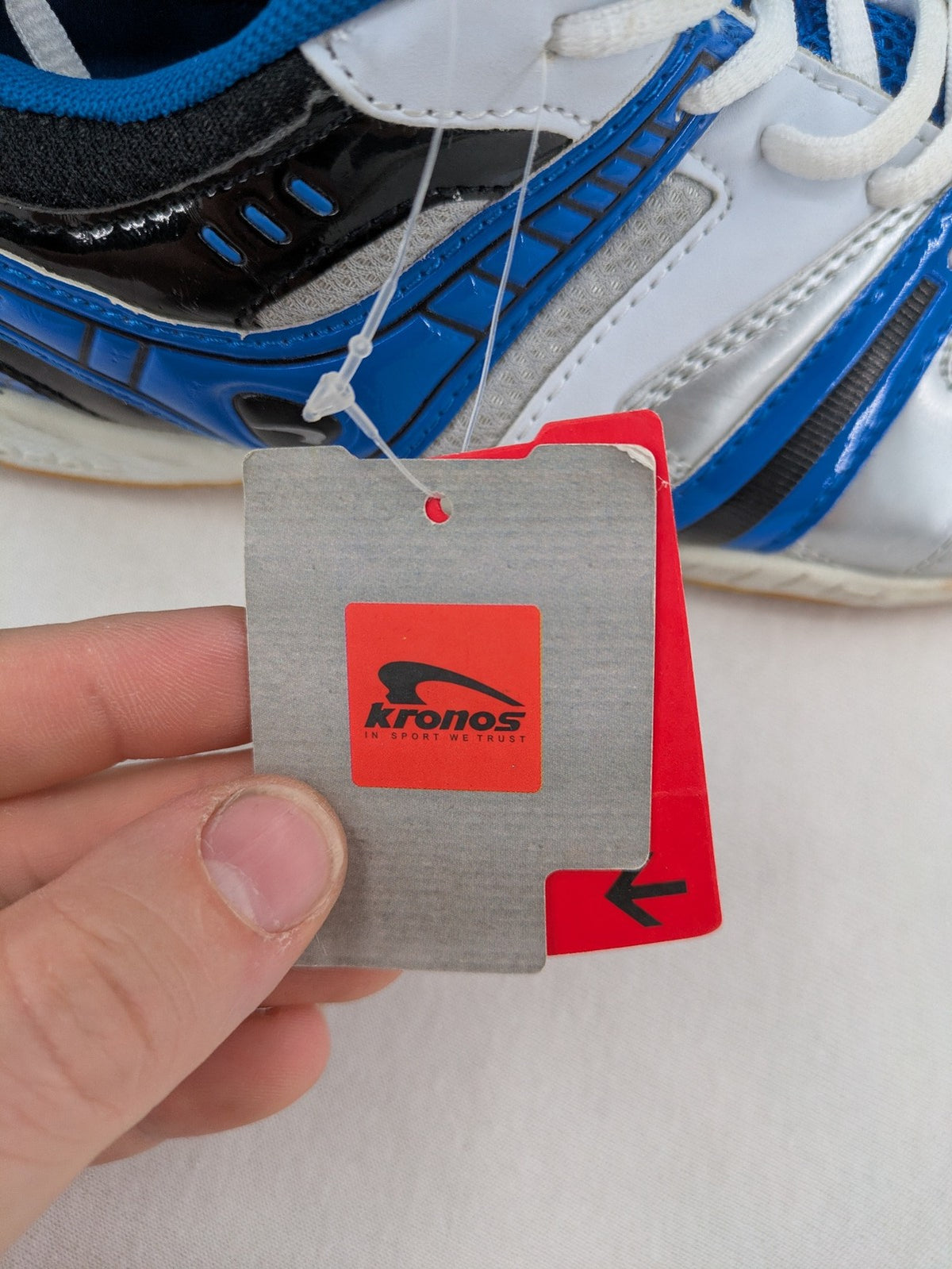 Kronos sports sneakers white, blue, and silver with durable rubber sole and classic design.