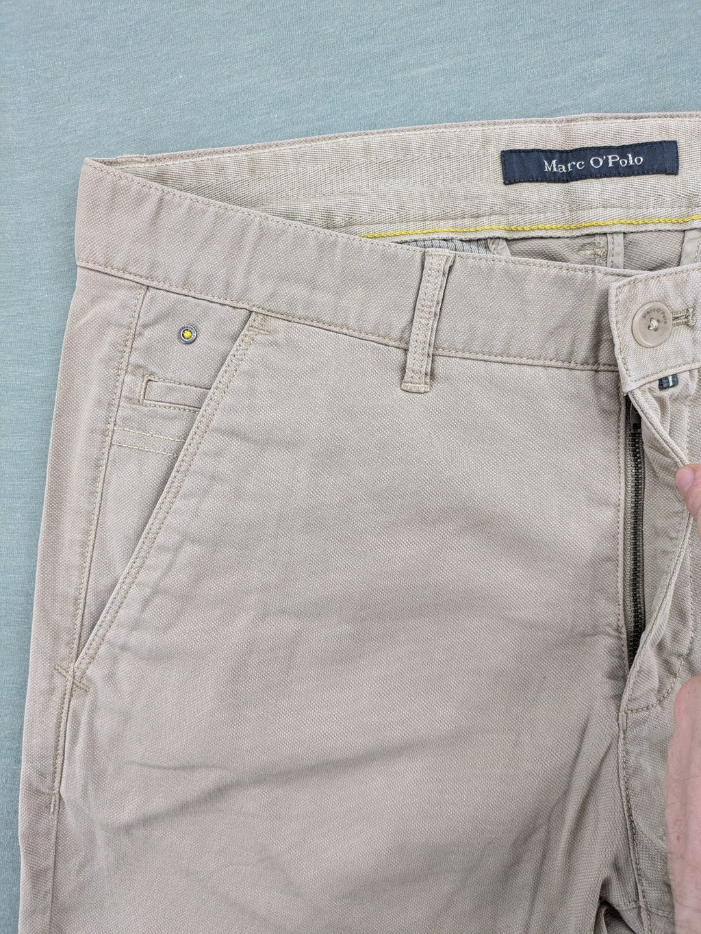 Marc O'Polo beige tapered fit chino pants, soft cotton stretch fabric, modern silhouette.