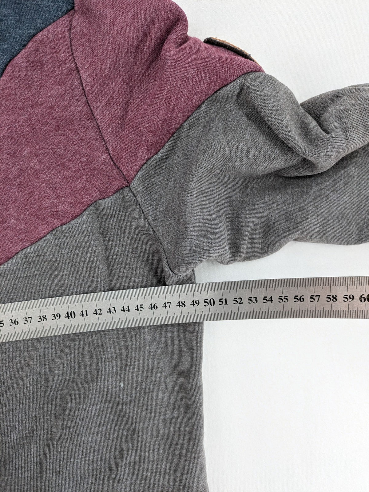 Naketano multicolor turtle neck jumper with button placket and anchor patches.