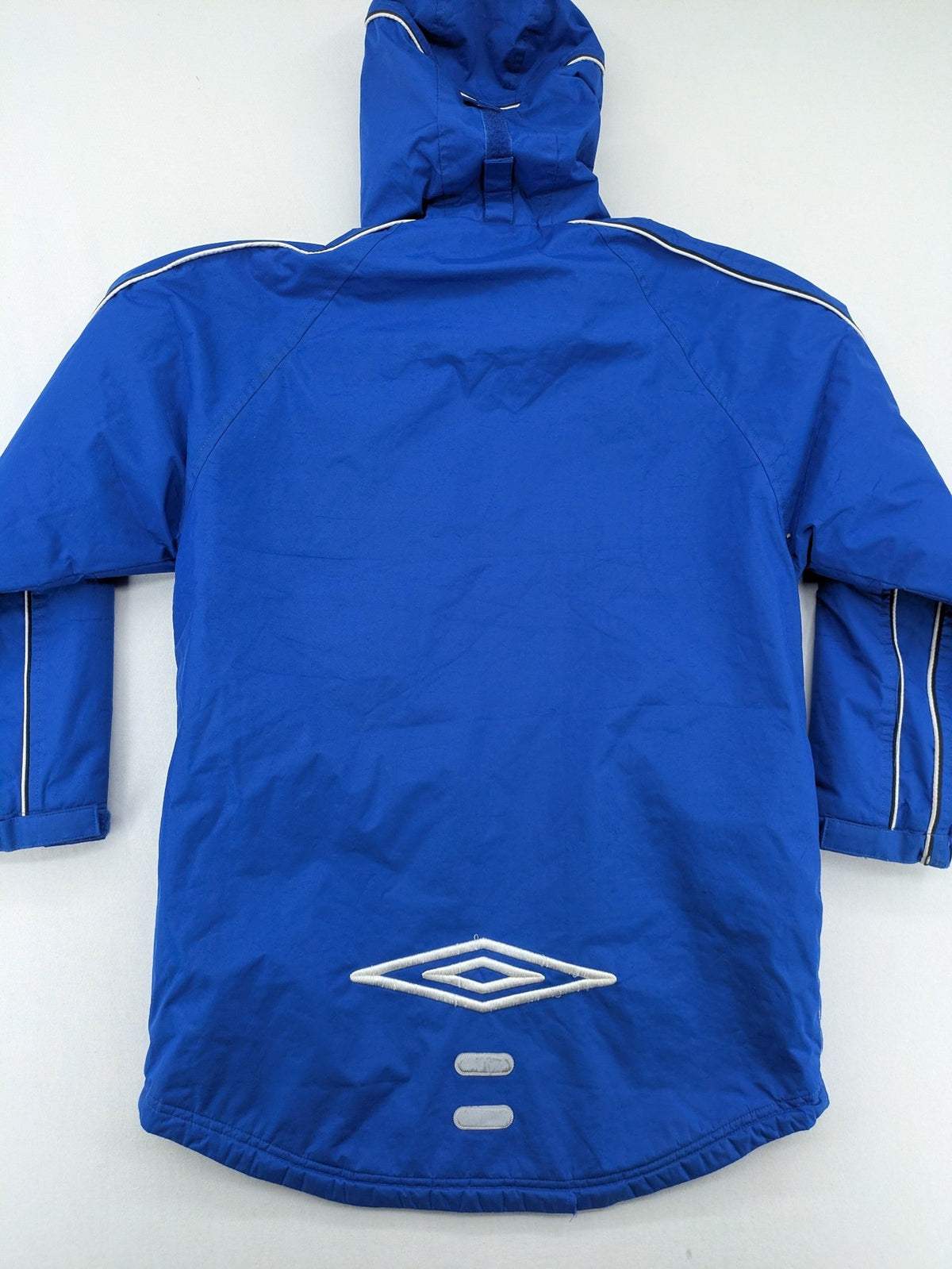 Umbro blue fleece-lined jacket with hood, reflective details, and white piping.