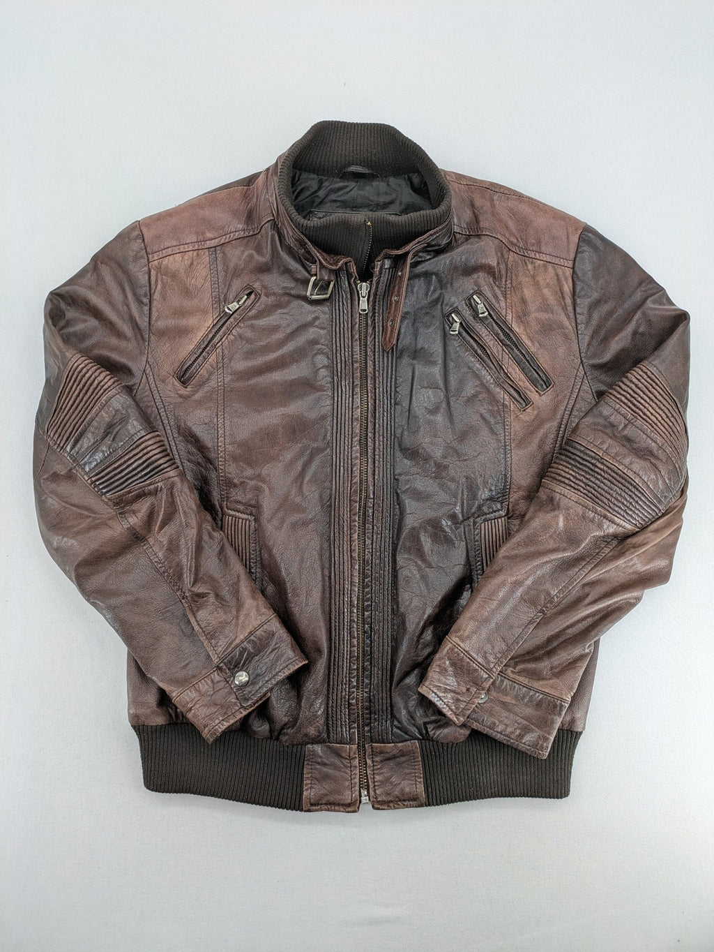 H&M green leather bomber jacket with ribbed collar and moto-style padding.