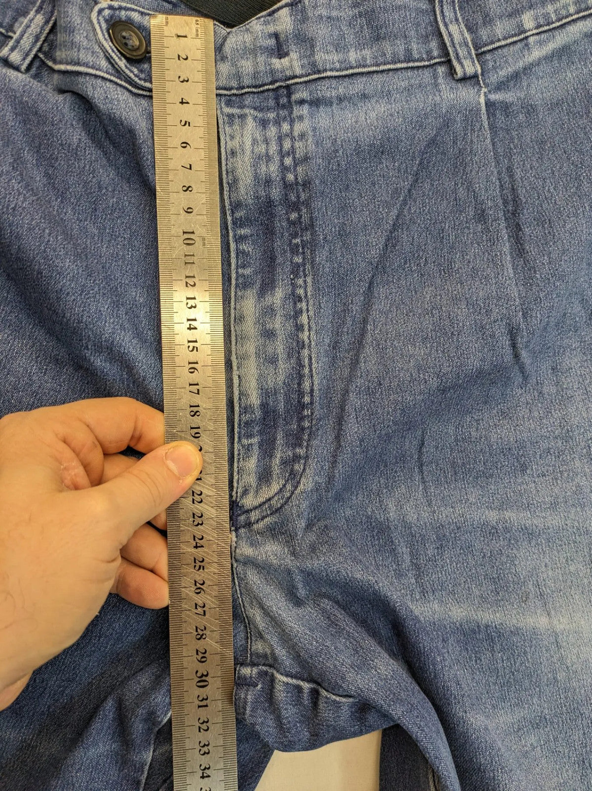 REI blue straight jeans with front pleats, zip fly, and buttoned back pockets.